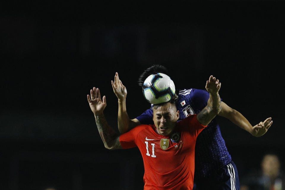 Chile's Eduardo Vargas, front, and Japan's Naomichi Ueda compete to head the ball during a Copa America Group C soccer match at Morumbi stadium in Sao Paulo, Brazil, Monday, June 17, 2019. (AP Photo/Victor R. Caivano)