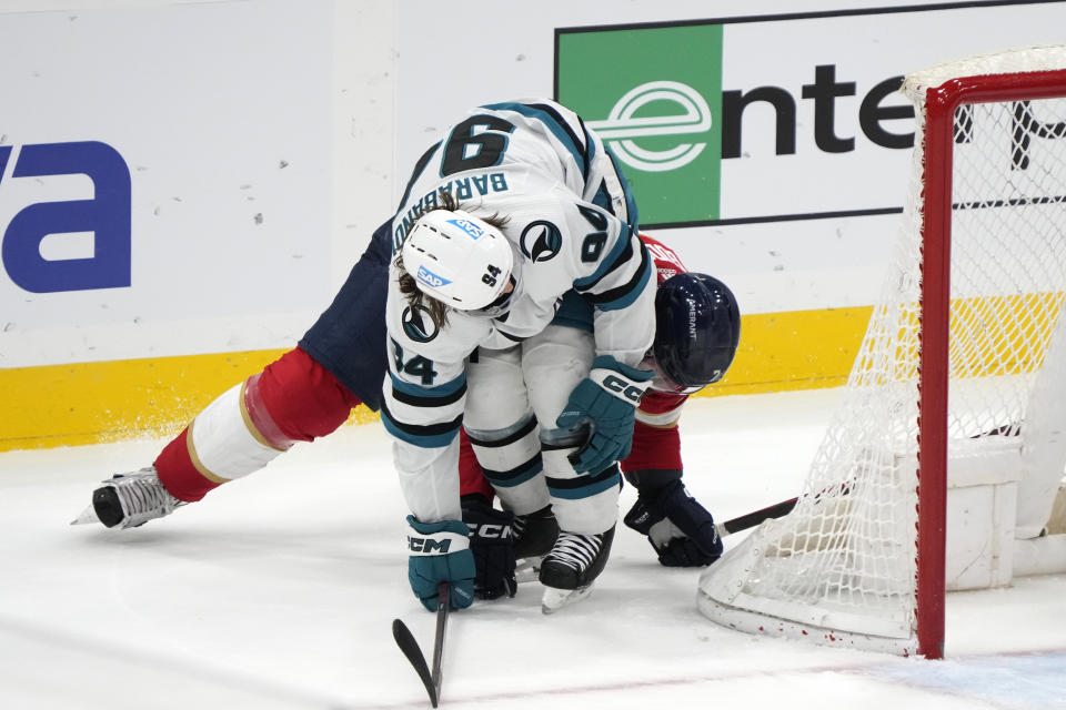 San Jose Sharks left wing Alexander Barabanov (94) and Florida Panthers defenseman Radko Gudas (7) collide as they round the net during the second period of an NHL hockey game, Thursday, Feb. 9, 2023, in Sunrise, Fla. (AP Photo/Wilfredo Lee)