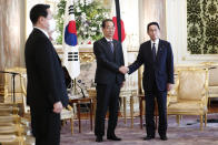 South Korea's Prime Minister Han Duck-soo, center, greets Japanese Prime Minister Fumio Kishida before their meeting at Akasaka Palace state guest house Han Duck-soo in Tokyo, Sept. 28, 2022. U.S. Vice President Kamala Harris is trying to bolster relations between Japan and South Korea to present a united front to growing Chinese influence, but tension and bad relations between the two countries are not helping(Rodrigo Reyes Marin/Pool Photo via AP)