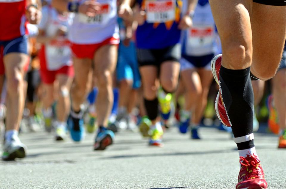 Low Section Of People Running On Street In Marathon