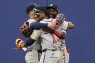 Atlanta Braves' Ronald Acuña Jr., center, hubs Jarred Kelenic, left, and Michael Harris II after a baseball game against the New York Mets, Saturday, May 11, 2024, in New York. The Braves won 4-1. (AP Photo/Frank Franklin II)