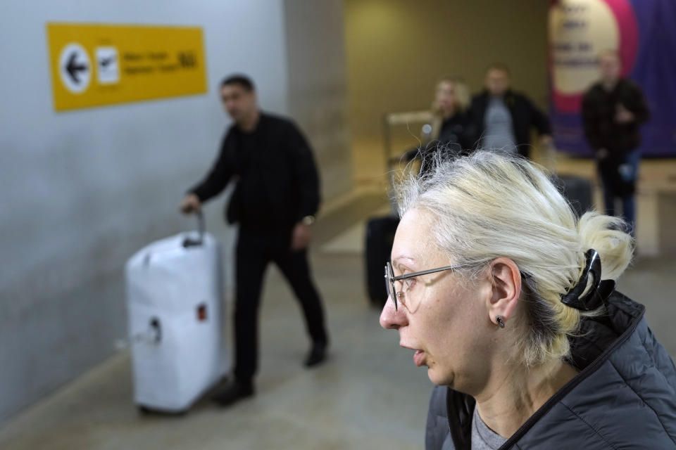 Yulia, a passenger from the Moscow-Belgrade flight operated by Air Serbia, speaks to the media at the airport in Belgrade, Serbia, Wednesday, Sept. 21, 2022. Large numbers of Russians rushed to book one-way tickets out of the country while they still could, after Russian President Vladimir Putin announced a partial mobilization of military reservists for the war in Ukraine. (AP Photo/Darko Vojinovic)