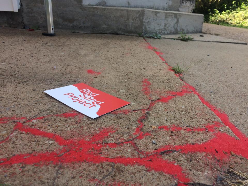 Red sand filled cracks in sidewalks throughout Cheatham County as part of the Red Sand Project, hosted by the Cheatham County Community Enhancement Coalition to raise awareness of human trafficking.