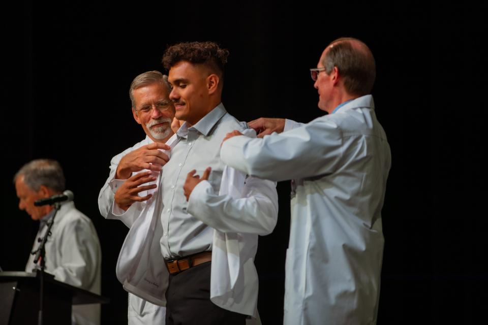 T.J. Brooks of Lubbock receives his white coat during Friday's ceremony held by the Texas Tech University Health Sciences Center at the Buddy Holly Hall of Performing Arts and Sciences.