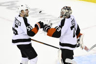 Philadelphia Flyers defenseman Rasmus Ristolainen (55) celebrates with goaltender Carter Hart (79) after the Flyers defeated the New Jersey Devils 2-1 in an NHL hockey game Thursday, Dec. 15, 2022, in Newark, N.J. (AP Photo/Bill Kostroun)