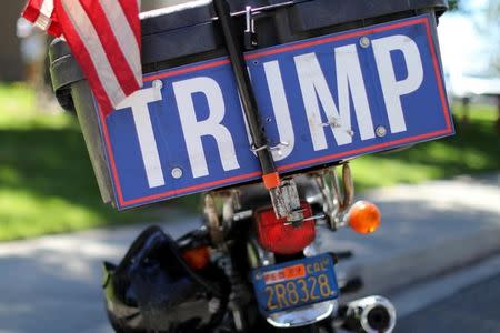 A lone pro-trump supporter parks his motorcycle across the street form protesters demonstrate against the Republican healthcare bill outside Republican Congressman Darrell Issa's office in Vista, California, June 27, 2017. REUTER Mike Blake/Files