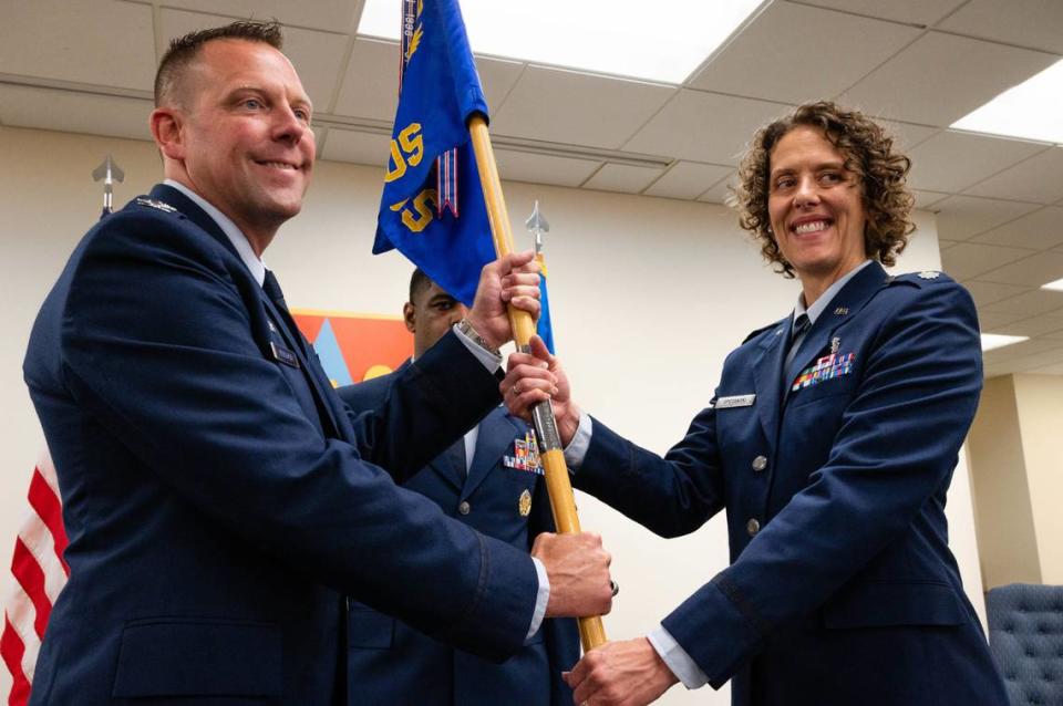 U.S. Air Force Lt. Col. Amy Spotanski, 375th Health Care Operations Squadron commander, accepts the guidon from Col. Richard Woodruff, 375th Medical Group commander, during a change of command ceremony at the Deltgen Auditorium on Scott Air Force Base. The 375th HCOS provides mission support to Scott AFB enabling mission readiness. Airman 1st Class Mark Sulaica/U.S. Air Force/375th Air Mobility Wing Public Affairs Office