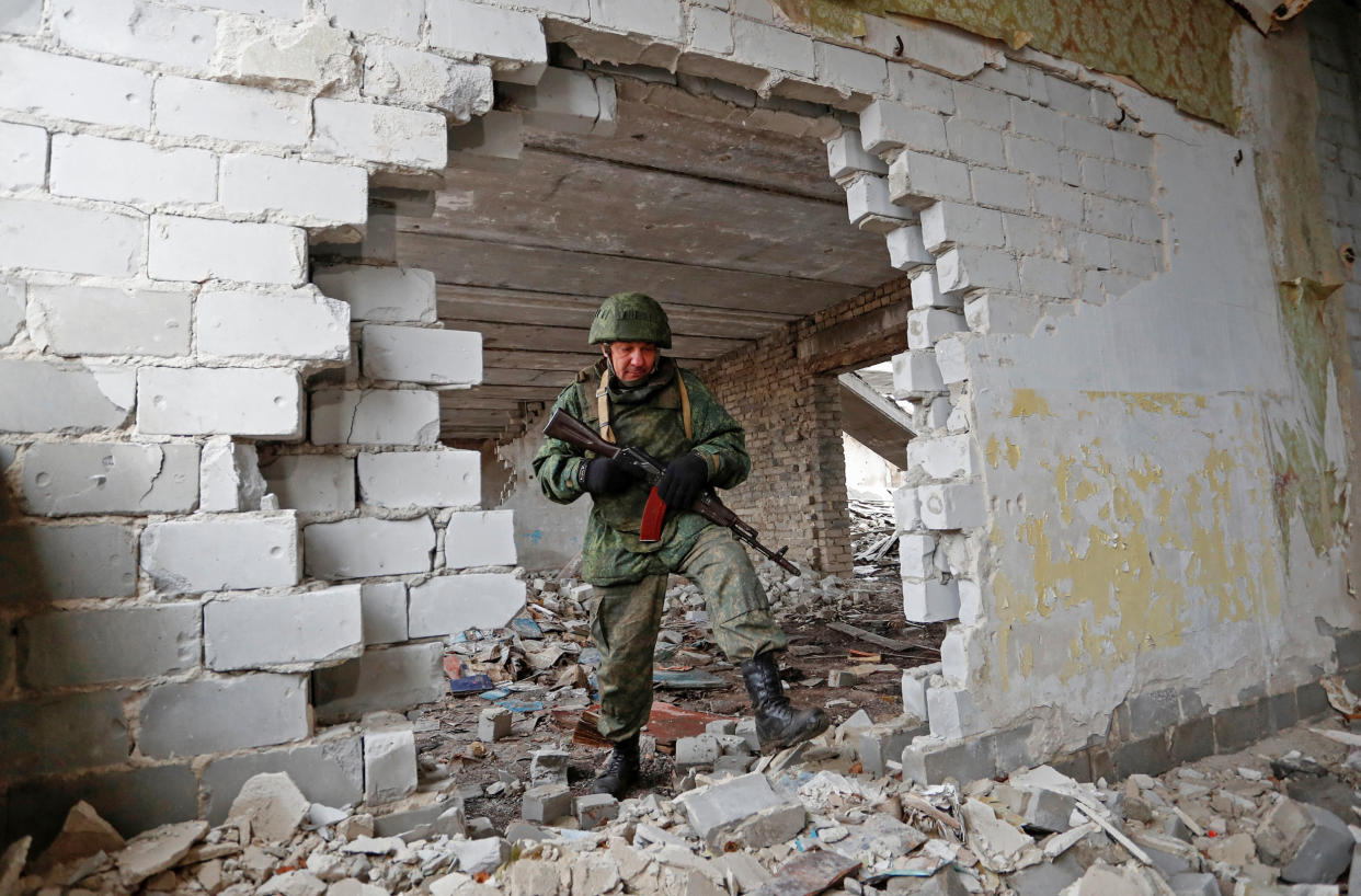 Image: Pro-Russian rebels patrol area near separation line in Luhansk region (Alexander Ermochenko / Reuters)