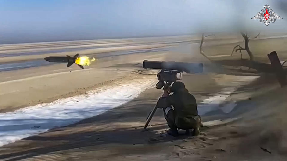 In this photo taken from video released by Russian Defense Ministry Press Service on Friday, Dec. 29, 2023, A Russian army soldier fires a Kornet anti-tank missile at Ukrainian positions. (Russian Defense Ministry Press Service via AP)