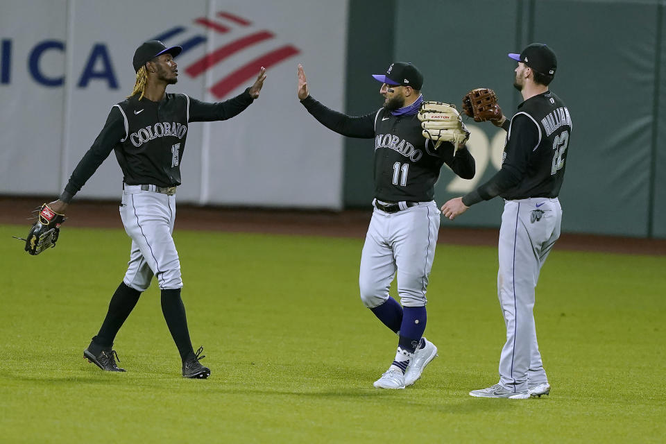 Colorado Rockies left fielder Raimel Tapia (15), center fielder Kevin Pillar (11) and right fielder Sam Hilliard (22) celebrate after a 7-2 victory against the San Francisco Giants in a baseball game on Monday, Sept. 21, 2020, in San Francisco. (AP Photo/Tony Avelar)