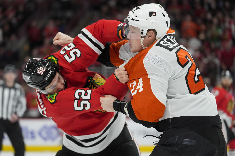Chicago Blackhawks center Reese Johnson, left, and Philadelphia Flyers defenseman Nick Seeler go at it during the third period of an NHL hockey game Wednesday, Feb. 21, 2024, in Chicago. The Flyers won 3-1. (AP Photo/Erin Hooley)