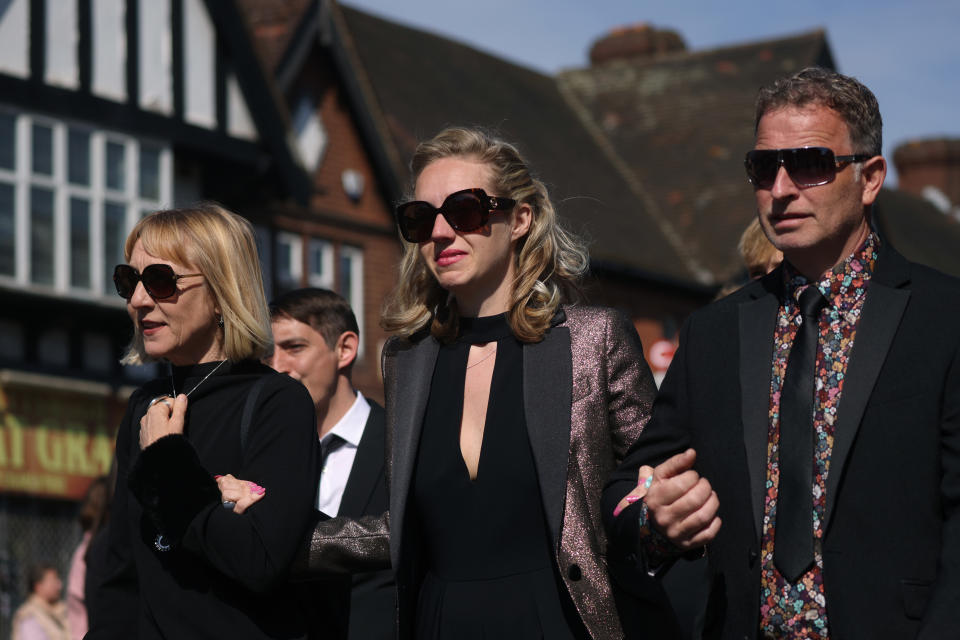 Tom Parker's wife Kelsey Parker is supported as she follows his funeral procession in south east London (Getty Images)
