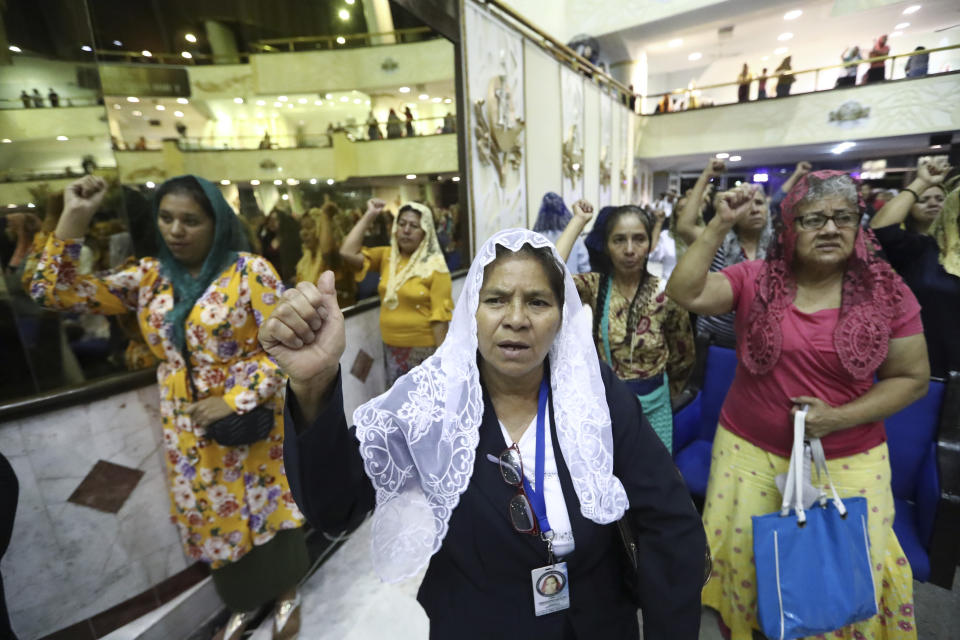 ADDS FIRST NAME - Women pray inside the "La Luz Del Mundo" or Light of the World church after they learned their church's leader Naasón Joaquín García was arrested in the U.S., in Guadalajara, Mexico, Tuesday, June 4, 2019. California authorities have charged Garcia, the self-proclaimed apostle of the Mexico-based church that claims over 1 million followers, with child rape, human trafficking and producing child pornography in Southern California. (AP Photo/Refugio Ruiz)