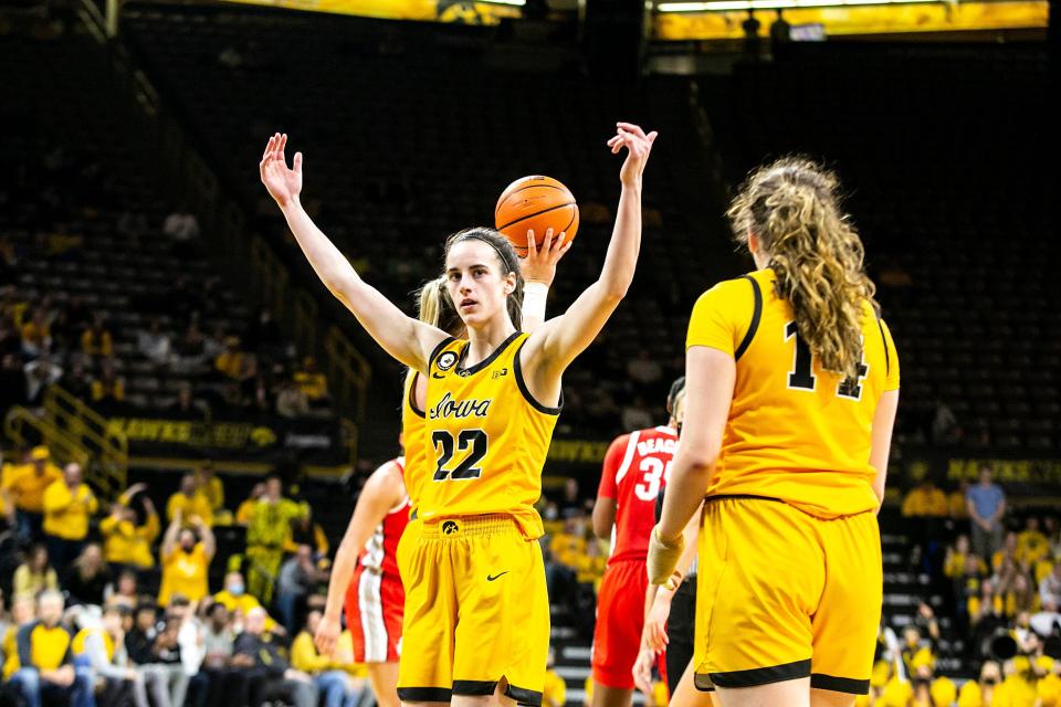 Iowa guard Caitlin Clark (22) pumps up the crowd after drawing a foul during a 2022 game against Ohio State at Carver-Hawkeye Arena.