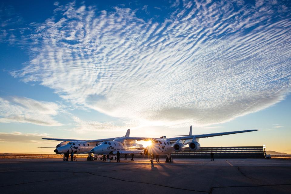 The Virgin Galactic aircraft against a partly cloudy sky