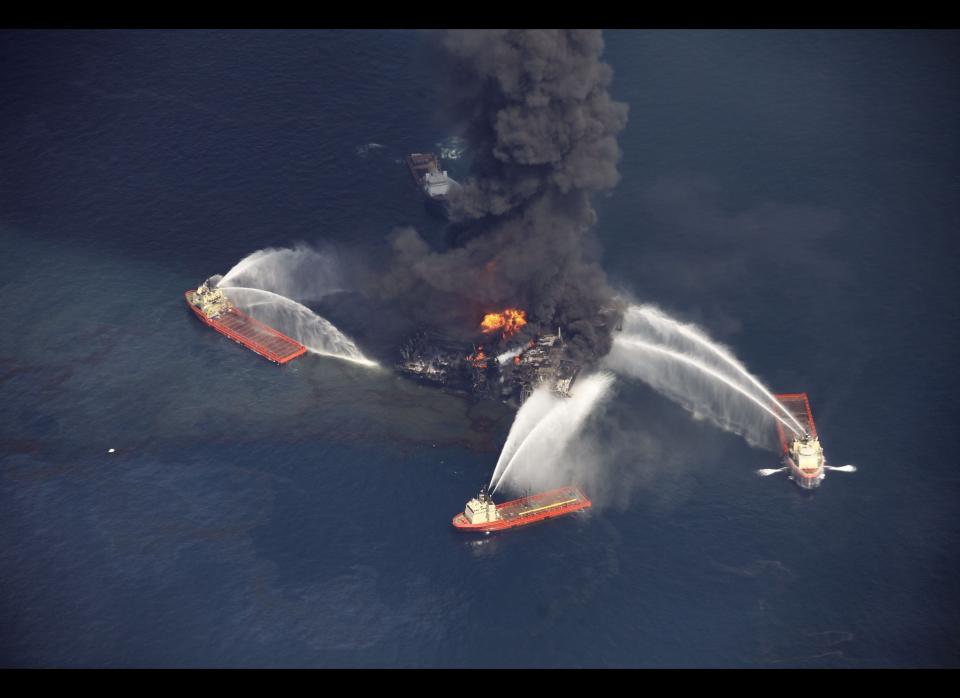 In this aerial photo taken in the Gulf of Mexico, more than 50 miles southeast of Venice on Louisiana's tip, an oil slick is seen as the Deepwater Horizon oil rig burns. (Gerald Herbert, AP)