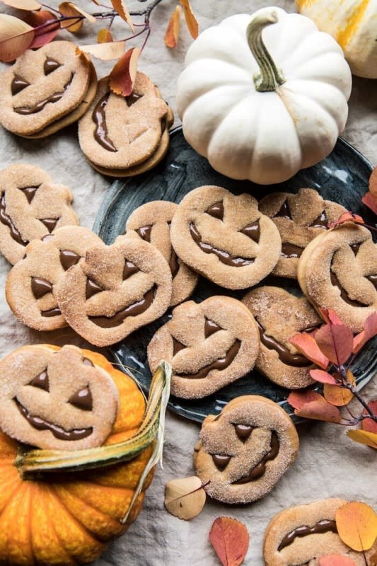 <p>Half Baked Harvest</p><p><strong>Get the recipe: <a href="https://www.halfbakedharvest.com/milk-chocolate-stuffed-jack-o-lantern-cookies/" rel="nofollow noopener" target="_blank" data-ylk="slk:Milk Chocolate Stuffed Jack-O’-Lantern Cookies;elm:context_link;itc:0;sec:content-canvas" class="link ">Milk Chocolate Stuffed Jack-O’-Lantern Cookies</a></strong></p>