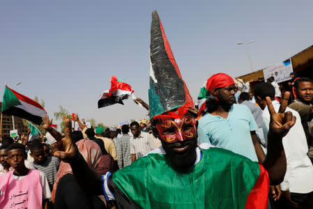 A Sudanese protester makes a victory sign outside the defense ministry compound in Khartoum, Sudan, April 25, 2019. REUTERS/Umit Bektas