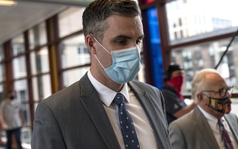 Former Minneapolis Police officer Thomas Lane (L) leaves a hearing at the Hennepin County Public Safety Facility. He is charged with aiding and abetting second-degree murder in the death of George Floyd  - Getty