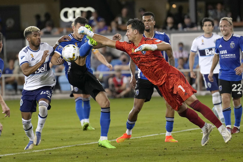 San Jose Earthquakes goalkeeper JT Marcinkowski (1) punches the ball away from Vancouver Whitecaps midfielder Pedro Vite during the second half of an MLS soccer match in San Jose, Calif., Sunday, Sept. 4, 2022. (AP Photo/Tony Avelar)