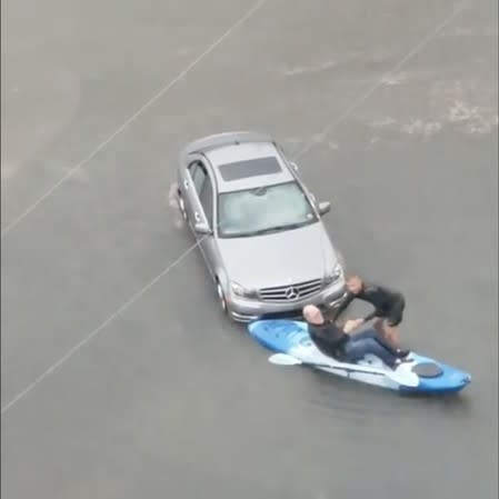 A man who was stranded in his flooded car is helped into a canoe, during heavy rains and flooding as Tropical Storm Barry heads toward New Orleans, Louisiana