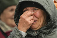A woman cries as she waits in a line after fleeing the war from neighbouring Ukraine at the border crossing in Medyka, southeastern Poland, Tuesday, April 5, 2022. Ukraine’s president plans to address the U.N.’s most powerful body after even more grisly evidence emerged of civilian massacres in areas that Russian forces recently left. (AP Photo/Sergei Grits)