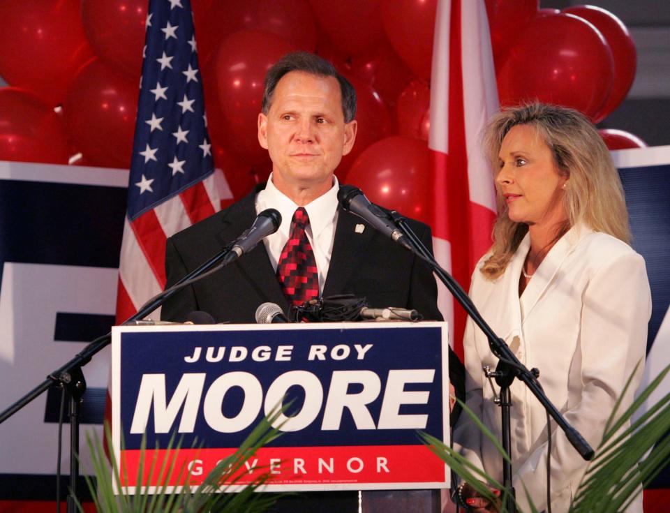 FILE - In this Tuesday, June 6, 2006 file photo, Judge Roy Moore stands with his wife, Kayla, after conceding the governor's race to Gov. Bob Riley, in Gadsden, Ala. (AP Photo/Butch Dill)