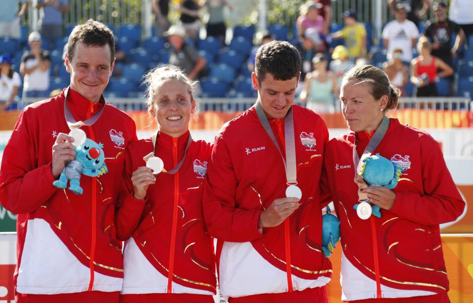 Alistair Brownlee, Jonathan Brownlee, Vicky Holland and Jessica Learmonth of England pose with their silver medals. REUTERS/David Gray