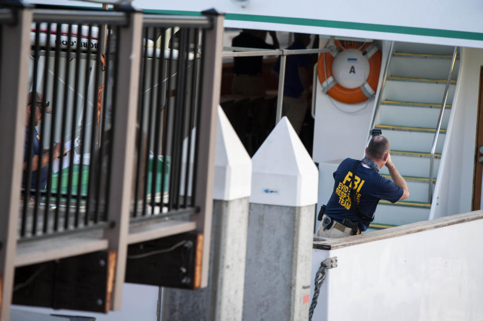 FBI investigators climb aboard the "Vision" a sister vessel to the scuba boat Conception to document its layout and learn more about the deadly pre-dawn fire in Santa Barbara, Calif., on Tuesday, Sept. 3, 2019. A fire raged through the boat carrying recreational scuba divers anchored near an island off the Southern California Coast on Monday, leaving multiple people dead. Authorities on Tuesday ended the search for survivors. (AP Photo/Christian Monterrosa)