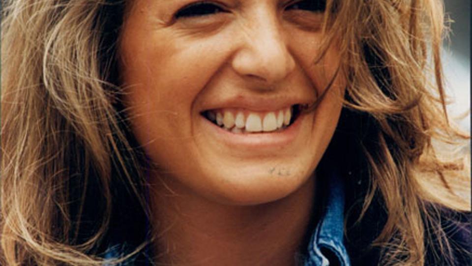 headshot of claudia fingeless light brown sunkissed wavy hair