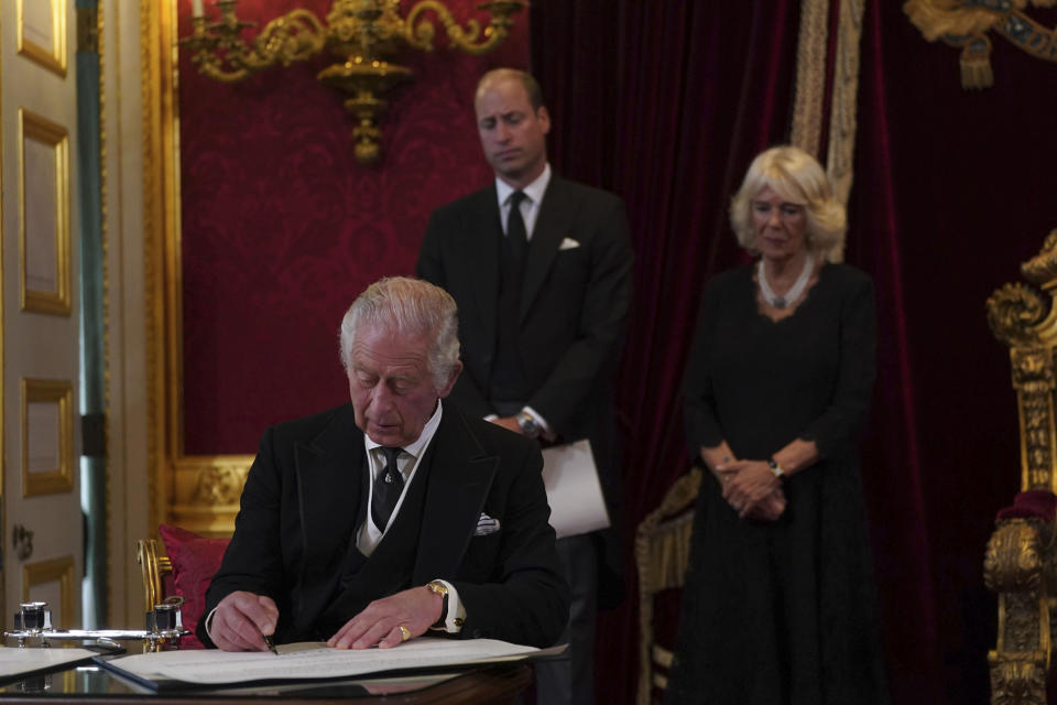 FILE - Britain's King Charles III signs an oath to uphold the security of the Church in Scotland during the Accession Council at St James's Palace, London, Saturday, Sept. 10, 2022, where he was formally proclaimed monarch. Charles automatically ascended to the throne when Elizabeth died Sept. 8 and he was officially proclaimed Britain’s monarch two days later in an ascension ceremony broadcast for the first time on television. (Victoria Jones/Pool Photo via AP, File)