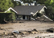 <p>A home is buried in flood debris in Montecito, Calif., Tuesday, Jan. 9, 2018. (Photo: Mike Eliason/Santa Barbara County Fire Department via AP) </p>