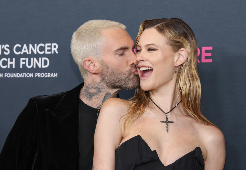 Adam kissing Behati's cheek