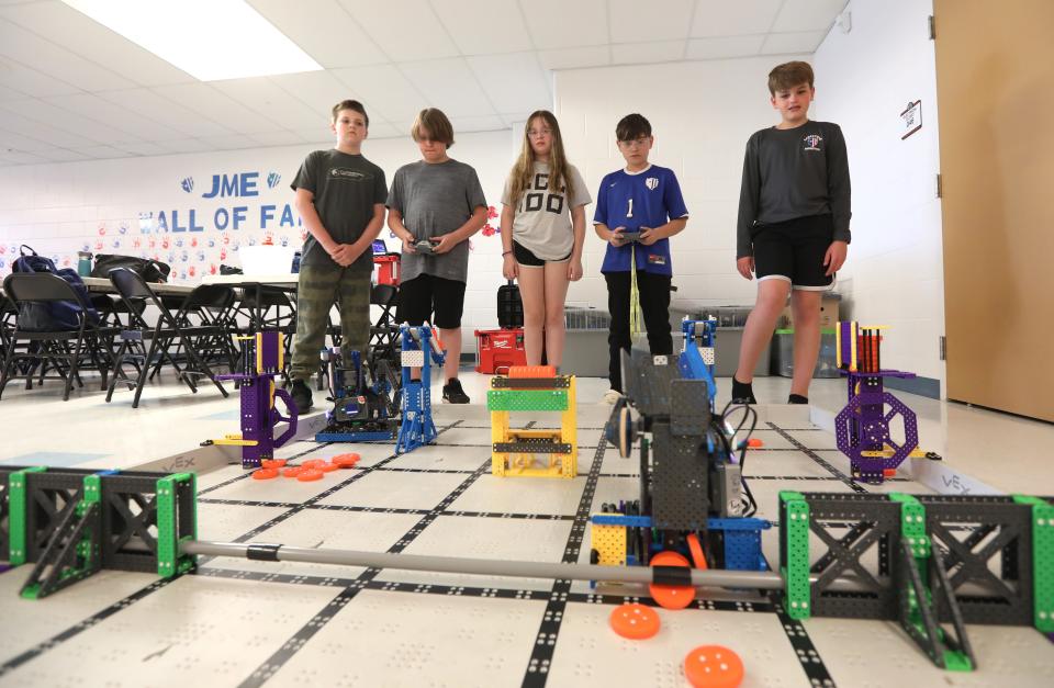 Owen Cranz, left, Cooper Matthews, Caitlin Montgomery, Damon Burkett and Micheal Emmert III are on the two teams from John McIntire Elementary School that qualified for the VEX Robotics World Championship. Not pictured is Emmett Martin.