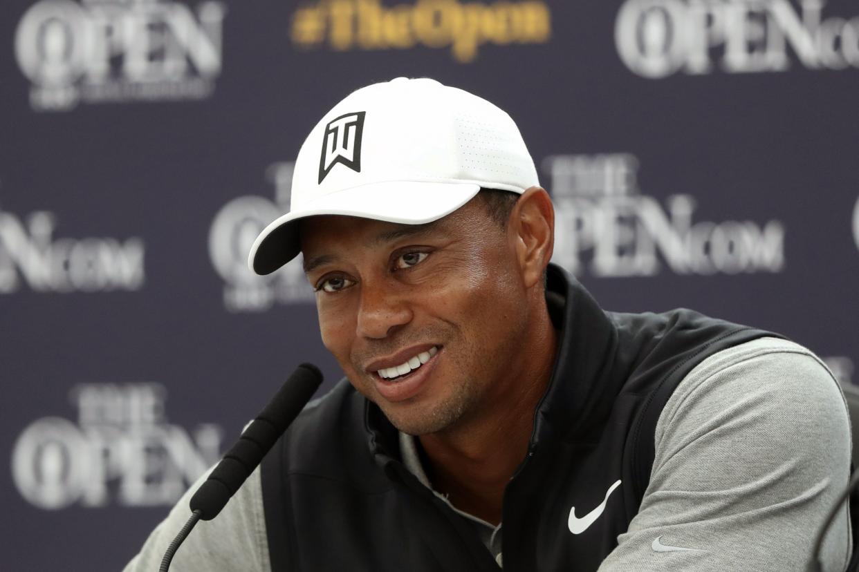 FILE - In this July 16, 2019, file photo, Tiger Woods speaks at a press conference ahead of the start of the British Open golf championships at Royal Portrush in Northern Ireland. 