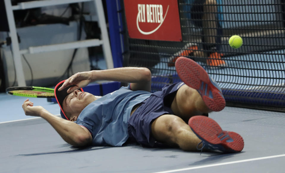 Alex De Minaur, of Australia, falls as he plays against Stefanos Tsitsipas of Greece, during the ATP Next Gen tennis tournament final, at the Rho fair, near Milan, Italy, Saturday, Nov. 10, 2018. (AP Photo/Luca Bruno)