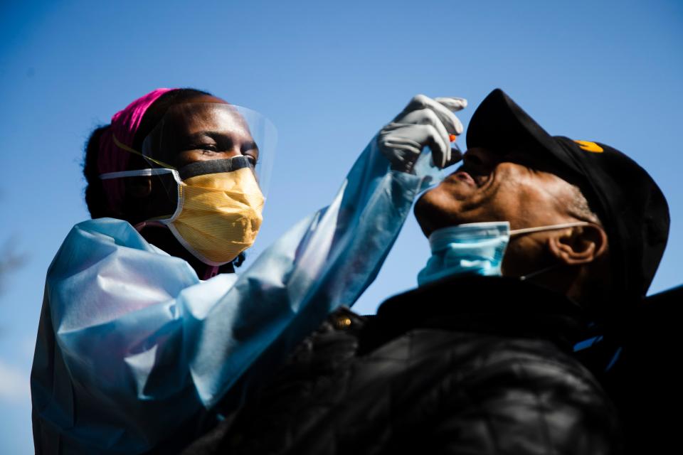 Dr. Ala Stanford administers a COVID-19 swab test on Wade Jeffries in the parking lot of Pinn Memorial Baptist Church in Philadelphia on April 22, 2020.