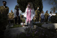 Israelis soldiers and families stand during a ceremony marking the annual Memorial Day for fallen soldiers at the Kiryat Shaul Military Cemetery in Tel Aviv, Israel, Wednesday, April 14, 2021. On Memorial Day, the most solemn day on Israel's national calendar, people stood at attention while a two-minute siren sounded around the country and held remembrance ceremonies at cemeteries. (AP Photo/Sebastian Scheiner)