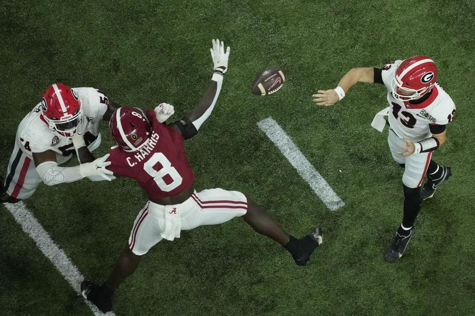 Georgia's Stetson Bennett thorws a pass during the first half of the College Football Playoff championship football game against Alabama Monday, Jan. 10, 2022, in Indianapolis. (AP Photo/Charlie Riedel)