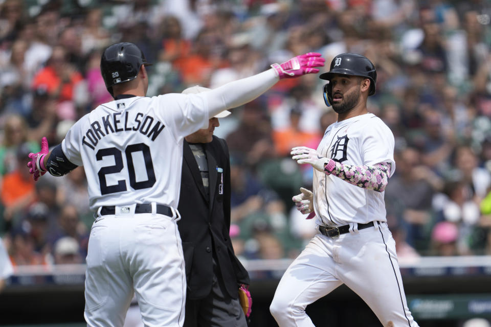 Detroit Tigers' Riley Greene, right, scores as Spencer Torkelson (20) looks on against the Seattle Mariners in the third inning of a baseball game, Sunday, May 14, 2023, in Detroit. (AP Photo/Paul Sancya)