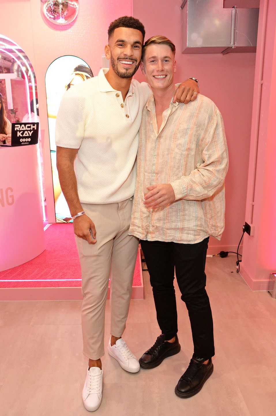 kai fagan and will young smiling together at the prettylittlething showroom launch, april 2023