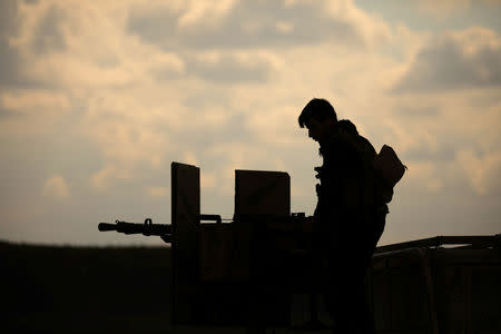 A member of Syrian Democratic Forces (SDF) stands on a pick up truck mounted with a weapon near Baghouz, Deir Al Zor province, Syria February 11, 2019. REUTERS/ Rodi Said