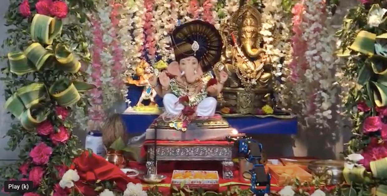 A robotic arm (below on right) is used to worship by maneuvering a candle in front of the Hindu god Ganesha. <a href="https://www.youtube.com/watch?v=r1pwR5yABnY&t=4s" rel="nofollow noopener" target="_blank" data-ylk="slk:Monarch Innovation;elm:context_link;itc:0;sec:content-canvas" class="link ">Monarch Innovation</a>