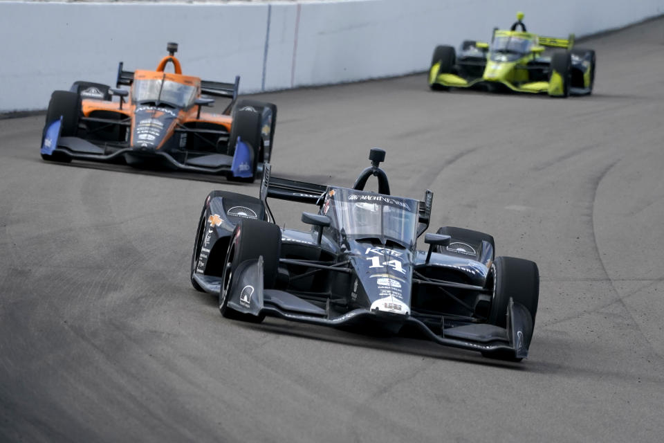 Tony Kanaan (14) drives into Turn 1 followed by Oliver Askew (7) and Charlie Kimball (4) during the IndyCar auto race at World Wide Technology Raceway on Sunday, Aug. 30, 2020, in Madison, Ill. (AP Photo/Jeff Roberson)