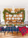 <p>If you're hosting for the holidays, don't settle for traditional. Instead of a tablecloth, layer a few plaid throw blankets onto your dining room table. Finish the look with greenery and citrus. </p>