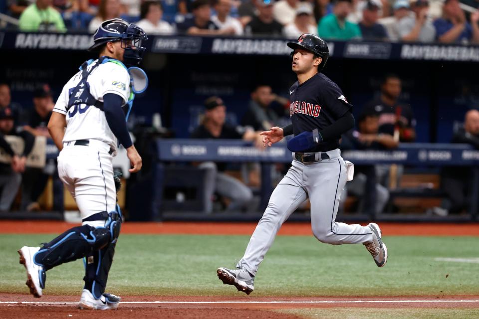Cleveland Guardians' Steven Kwan runs past Tampa Bay Rays catcher Rene Pinto to score during the third inning of a baseball game Saturday, Aug. 12, 2023, in St. Petersburg, Fla. (AP Photo/Scott Audette)