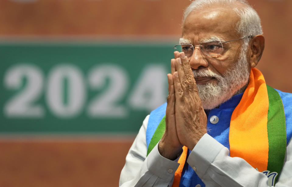 Indian Prime Minister Narendra Modi greets during the unveiling of his Hindu nationalist Bharatiya Janata party’s election manifesto in New Delhi, India, April 14, 2024. Modi is campaigning for a third term in the general election starting Friday. (AP Photo/Manish Swarup)