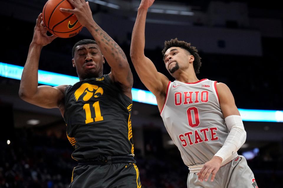 Jan 21, 2023; Columbus, OH, USA;  Ohio State Buckeyes guard Tanner Holden (0) tries to tip the ball away from Iowa Hawkeyes guard Tony Perkins (11) during the first half of the NCAA division I men’s basketball game between the Ohio State Buckeyes and the Iowa Hawkeyes at Value City Arena. Mandatory Credit: Joseph Scheller-The Columbus Dispatch