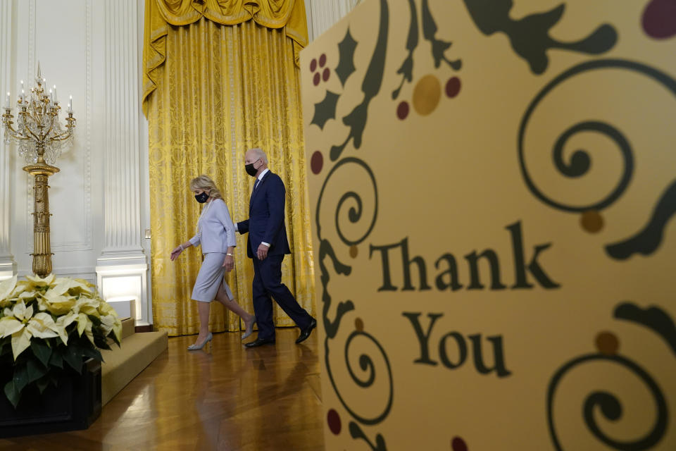 President Joe Biden and First Lady Jill Biden arrive at the Menorah lighting in the East Room of the White House. - Credit: AP