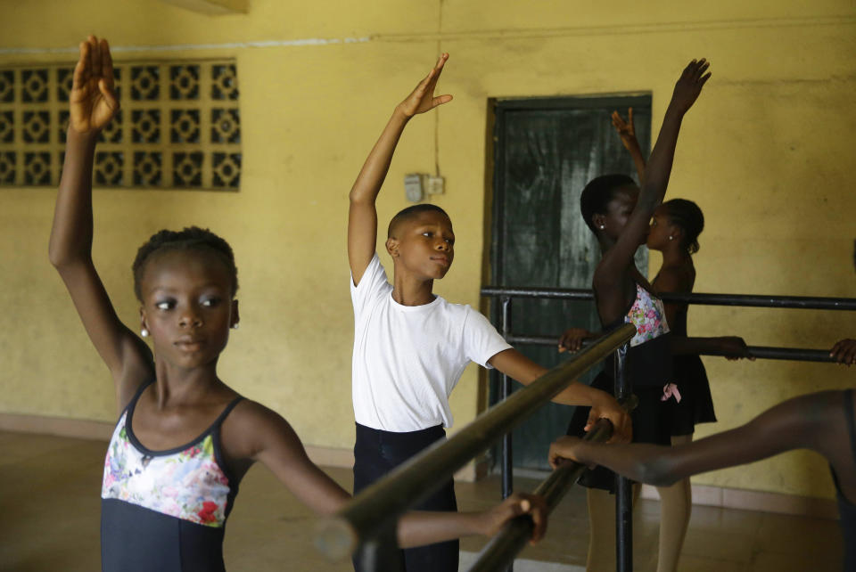 Ballet dancer Anthony Mmesoma Madu, center, rehearses with other dance students in Lagos, Nigeria on Aug. 18, 2020. Cellphone video showing the 11-year-old dancing barefoot in the rain went viral on social media. Madu’s practice dance session was so impressive that it earned him a ballet scholarship with the American Ballet Theater in the U.S. (AP Photo/Sunday Alamba)
